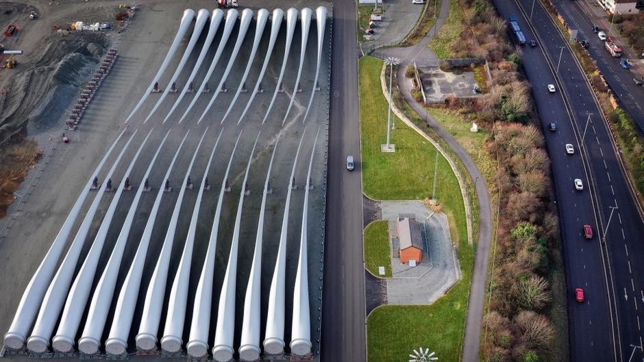 An aerial view shows wind turbine blades stored on the quayside ready for shipping at the Siemens Gamesa blade factory in Hull, northeast England, on January 28, 2022. Siemens Energy reported a 4.59-billion-euro (USD 5-billion) annual loss on November 15, 2023, dragged down by a crisis in its wind power unit, a day after a government-backed rescue package was unveiled for the German group. While large parts of its business, such as those related to gas and power grids, were healthy, the results were hit by 
