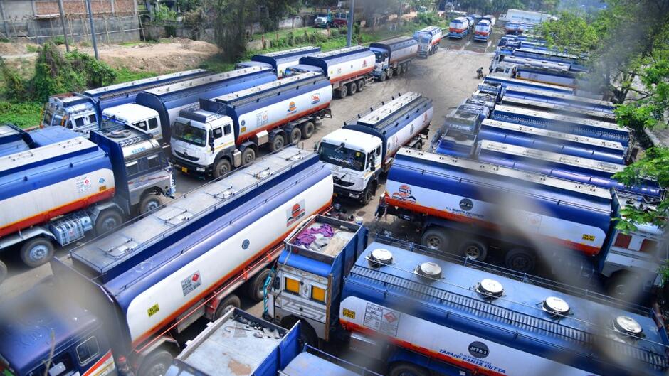 Trucks wait outside the Guwahati Refinery operated by Indian Oil Corporation, in Guwahati (India), 2023