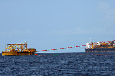 Oil being offloaded onto a tanker from a giant FPSO offshore Angola.