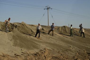 Image of workers in China handling waste from rare earth processing plants, near the city of Baotou in Inner Mongolia (China).